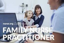 Family nurse practitioner taking notes on computer with mother and daughter in background