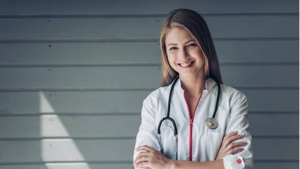 Doctor with rolled up sleeves smiling at the camera