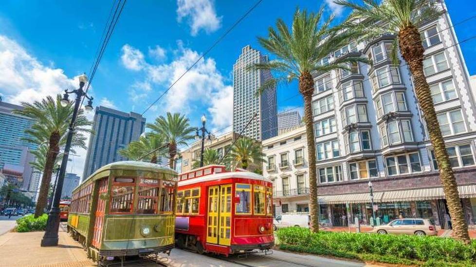 Street cars going down the street in sunny New Orleans