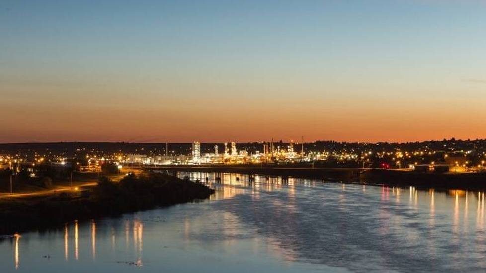 River in Montana at dusk with city in background